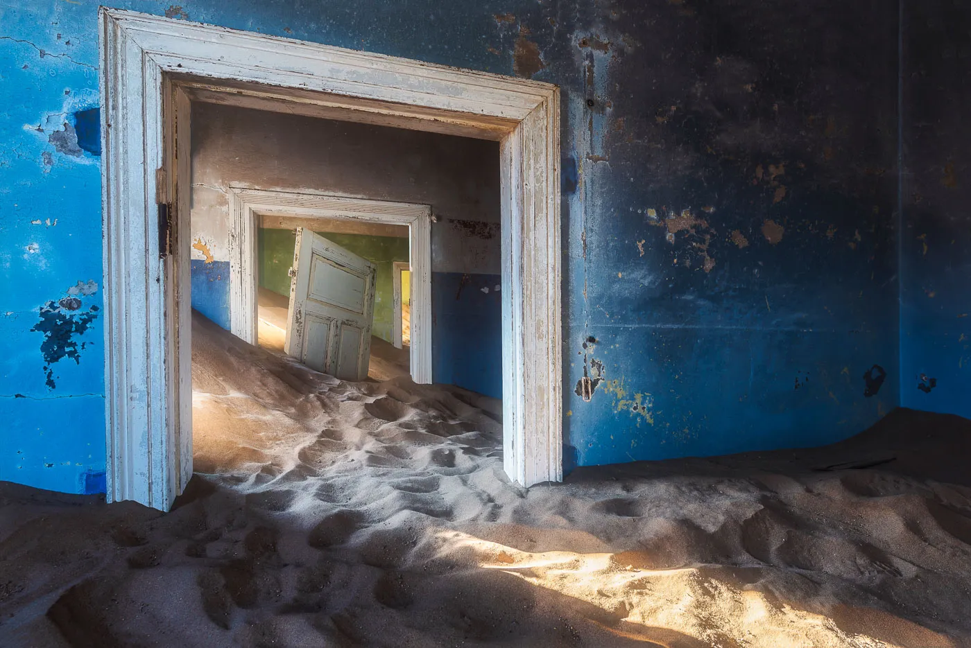 Sand-filled abandoned house in Kolmanskop ghost town, Namibia