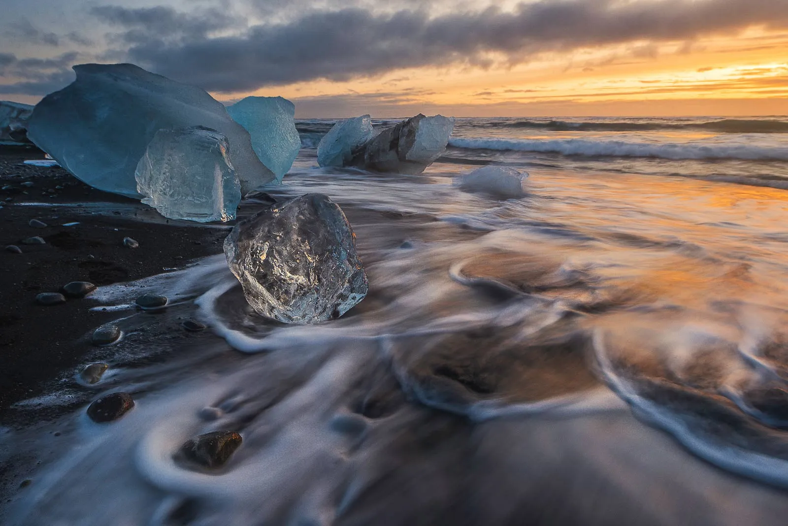 Ice blocks on Diamond Beach with silky water, Iceland