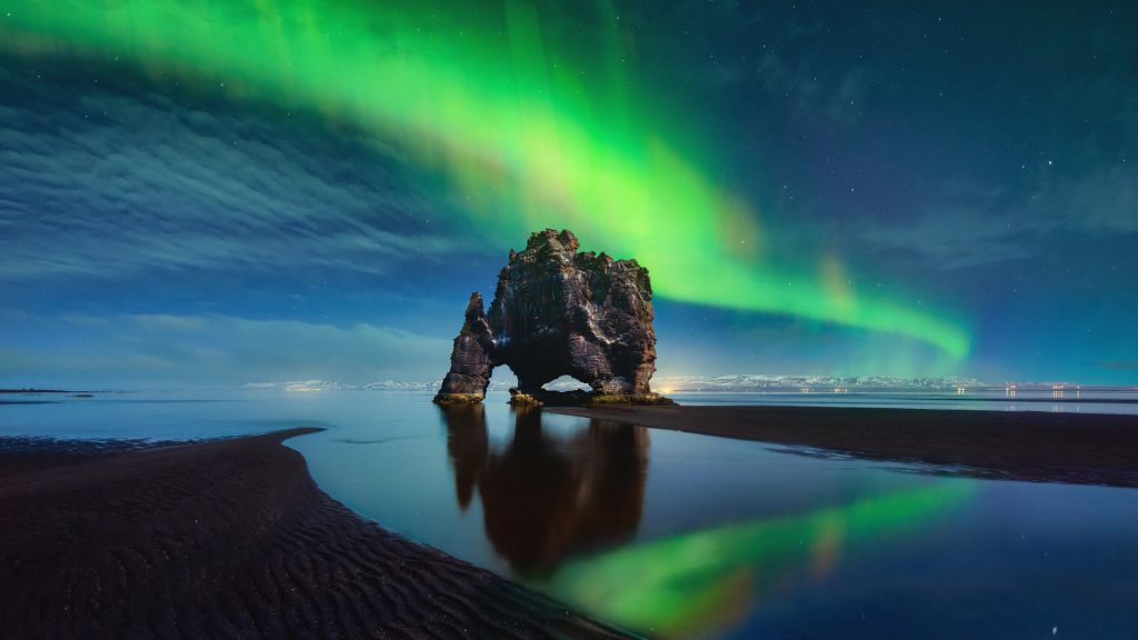 auroras boreales en Hvitserkur reflejadas en el agua de Islandia