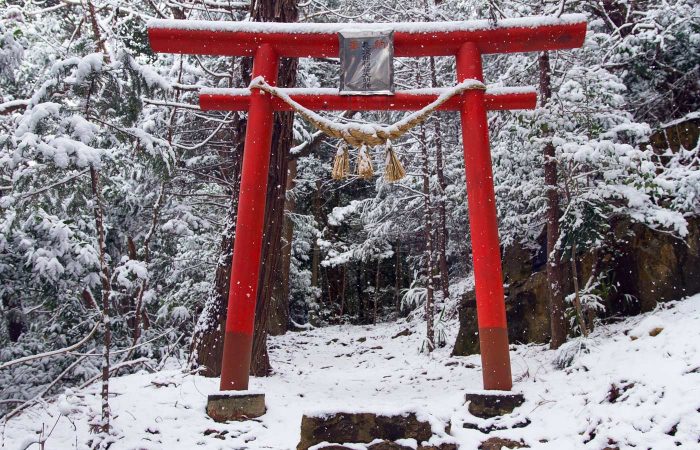 Red torii in Fukushima city on a snowing winter day