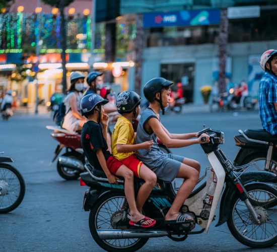 kids driving a motorcycle in Saigon, Vietnam
